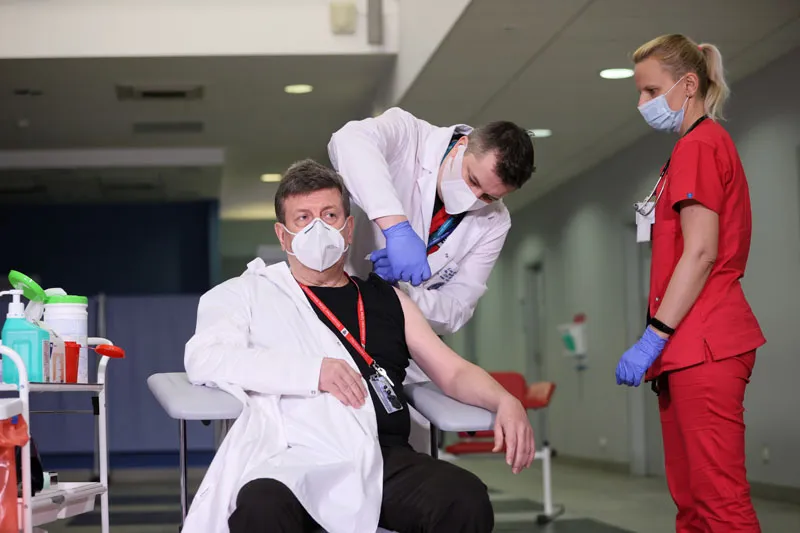 Dyrektor CSK MSWiA w Warszawie prof. nadzw. dr hab. n. med. Waldemar Wierzba (L) i lekarz chorób zakaźnych Agnieszka Szarowska (P) podczas szczepienia przeciw koronawirusowi Covid-19 na terenie Centralnego Szpitala Klinicznego MSWiA przy ul. Wołoskiej w Warszawie. Fot. PAP/Leszek Szymański