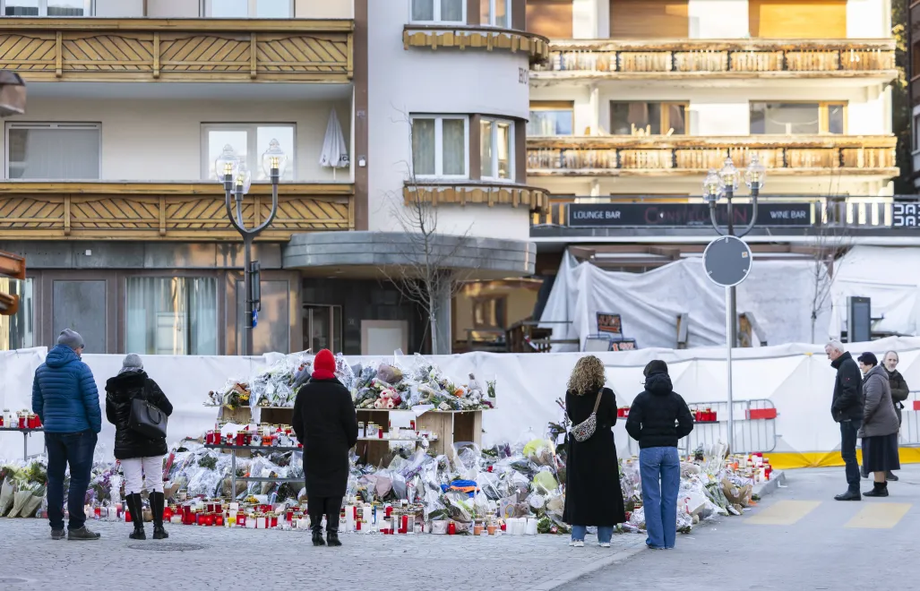Kwiaty i znicze przed miejscem tragedii w Crans-Montanie, fot. PAP/EPA/KEYSTONE/CYRIL ZINGARO
