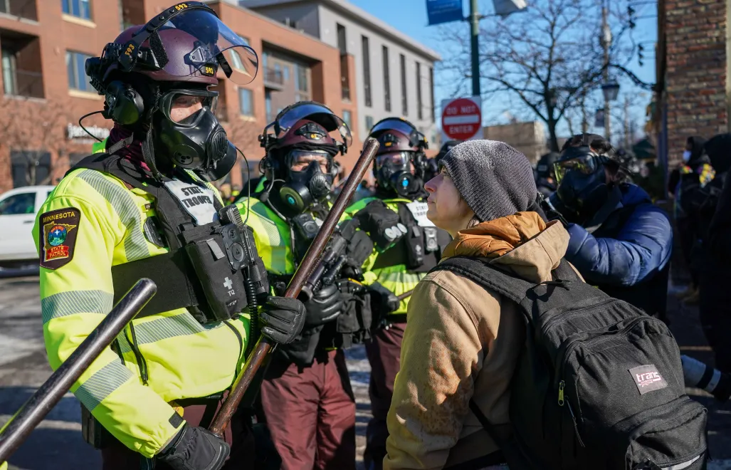Protestujący konfrontuje się z funkcjonariuszami federalnymi po śmiertelnej strzelaninie w Minneapolis w stanie Minnesota, USA. Fot. PAP/EPA/CRAIG LASSIG