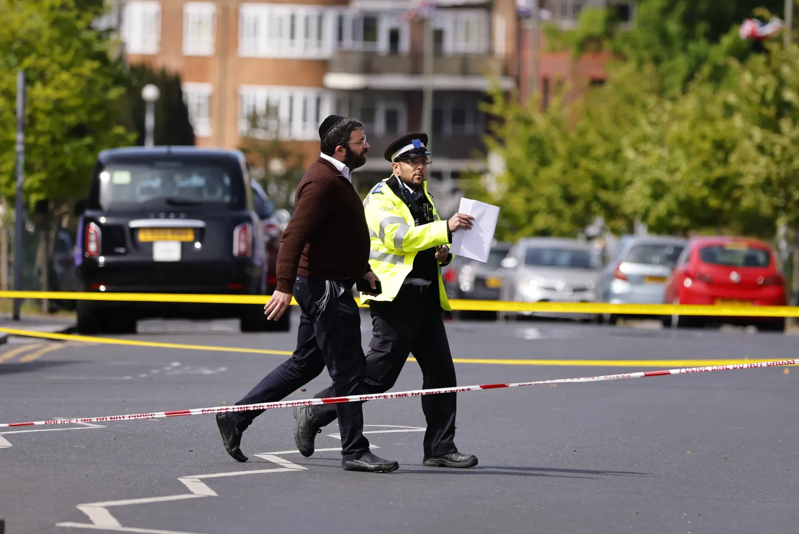 Policjant i członek społeczności żydowskiej na miejscu zdarzenia, fot. PAP/EPA/TOLGA AKMEN