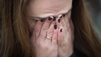 Kobieta zakrywająca twarz, zdjęcie ilustracyjne. Fot. PAP/Grzegorz Michałowski