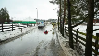  Strażacy przepompowują wodę z roztopów na drodze lokalnej w Otominie k. Gdańska. Fot. PAP/Adam Warżawa 