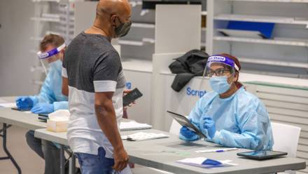 Pasażerowie przylatujący poddawani są testom na obecność COVID-19 Fot. PAP / TIM CARRAFA / POOL 