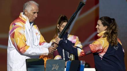 Giovanni Malago trzyma pochodnię z płomieniem olimpijskim podczas sztafety z pochodnią na Igrzyska Olimpijskie Mediolan-Cortina 2026 Fot. PAP/EPA/MASSIMO PERCOSSI